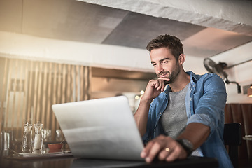 Image showing Thinking, laptop and man doing research in a coffee shop and reading for a freelance assignment. Pensive, technology and male freelancer working on a project with a computer at a cafe or restaurant.