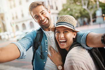 Image showing Tourist selfie, happy couple and outdoor for travel on a city street for happiness and holiday memory. Face of a man and a woman laughing on urban road for adventure, journey or vacation for freedom