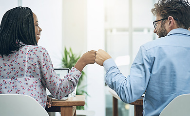 Image showing Back, teamwork and fist bump with business people in their office, working together on a company project. Motivation, collaboration and hand gesture with colleagues celebrating success at work