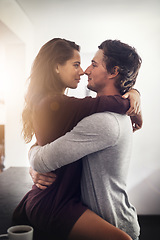 Image showing Intimate, passion and a couple kissing in the kitchen of their home together in the morning for romance. Kiss, love or sexy with a man and woman in their house for romantic intimacy or bonding