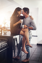 Image showing Love, intimate and a couple kissing in the kitchen of their home together in the morning for romance. Kiss, passion or sexy with a man and woman in their house for romantic intimacy or bonding