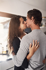 Image showing Young, couple and kissing in home for love, romantic bond and intimacy of special moment together. Man, woman and romance of partners with kiss for happy relationship, passionate affection and care