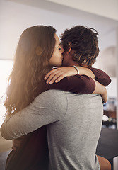 Image showing Couple, hug and kiss in home for love, care and bonding for quality time together with trust, loyalty and happiness. Happy young man, woman and kissing for affection, romance or intimate relationship