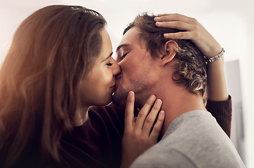 Image showing Face, couple and kiss for love, care and intimate moment for anniversary, honeymoon and bonding together at home. Happy young man, woman and kissing with passion, romance and lovers in relationship