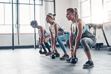 Image showing Kettlebell, training and women with workout, exercise and performance for wellness, healthy lifestyle or self care. Female athletes, friends or group with gym equipment, sports and stretching routine