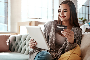 Image showing Happiness, online shopping and credit card, woman on sofa and mobile app on tablet, internet banking in home. Technology, cashback payment and happy girl on couch on retail website or digital shop.