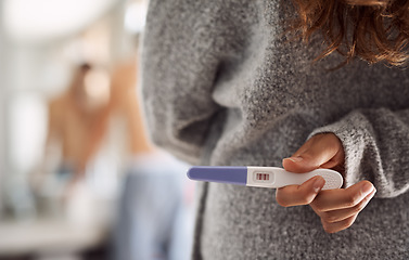 Image showing Closeup, surprise and hands of a woman with a pregnancy test for husband at home. Showing, back and a person holding and hiding a tool with pregnant results during announcement to a man in a house