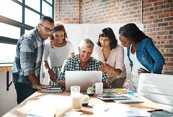 Image showing Diversity, group of colleagues and using a laptop together or collaborating on a new project and in a modern office. Teamwork, happy businesspeople or in a meeting or brainstorm and at the workplace