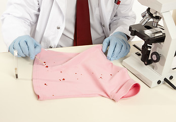 Image showing Forensic swabbing a stain