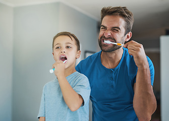 Image showing Happy, brushing teeth and father with son in bathroom for morning routine, bonding and dental. Oral hygiene, cleaning and smile with man and child in mirror of family home for self care and wellness