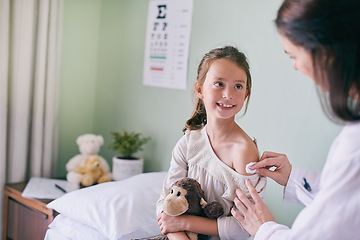 Image showing Healthcare, children and a girl at the pediatrician for an appointment or checkup in the hospital. Medical, covid and vaccine with an adorable little female child sitting on a bed in the clinic