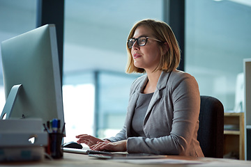 Image showing Computer, typing and business woman in office working late on project at night alone. Desktop, professional and female person writing email, report or planning, reading and overtime for deadline.