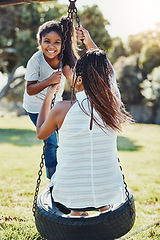 Image showing Mother with daughter on swing at park, playing together with happiness and fun outdoor. Love, care and bonding with happy family in nature, woman and girl enjoying time at playground with freedom