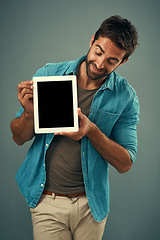 Image showing Man, tablet and mockup screen for advertising, marketing or branding against a grey studio background. Happy male person with smile showing technology display or mock up space for advertisement