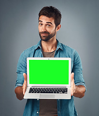Image showing Man, laptop and portrait with mockup green screen for advertising or marketing against a grey studio background. Male person showing computer display, chromakey or mock up space for advertisement