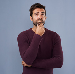 Image showing Thinking, confused and face of man in studio with unsure, uncertain and thoughtful on gray background. Doubtful, mockup space and isolated male person skeptical for decision, choice and question