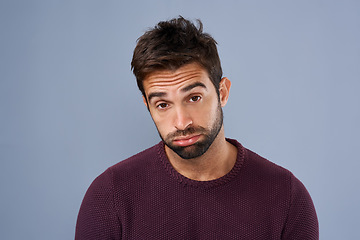 Image showing Bored, portrait and annoyed man in studio tired and moody against a grey background space. Fatigue, face and man with negative attitude posing with exhasuted expression while standing isolated