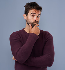 Image showing Idea, thinking and portrait of man in studio with unsure, wonder and thoughtful on blue background. Doubt, mockup space and face of isolated male person skeptical for decision, choice and question