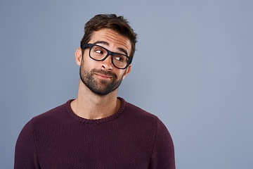 Image showing Mockup, thinking and face of man in studio with announcement, information and news space. Wondering, thoughtful mock up and male person looking for decision, choice and question on gray background