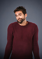 Image showing Confused, shrug and portrait of man in studio unsure against a grey background space. Doubt, face and shrugging male with dont know expression, puzzled and pensive with person with question isolated