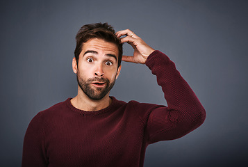 Image showing Confused, worry and portrait of man in studio with doubt, scratch head and thoughtful on gray background. Thinking, mockup space and funny face of male person wonder for decision, choice and question