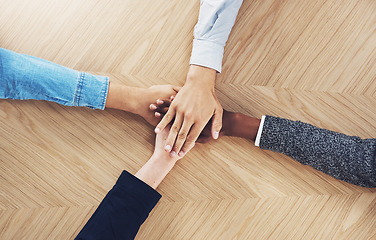 Image showing Teamwork, above or hands of business people in support for faith, community or strategy plan in office. Vision, diversity or employees in group collaboration with hope or mission for goals together