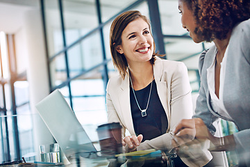 Image showing Meeting, businesswomen brainstorming or talking and together in office at work. Teamwork or collaboration, friends or women coworkers and female colleagues discussion or talking at desk in workplace