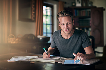 Image showing College homework, studying and a man with a tablet for research, education and elearning. Smile, working and a male student with technology for information and planning for an exam in a house