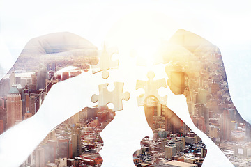 Image showing Problem solving, city and hands of people with puzzle pieces in a studio for teamwork or partnership. Collaboration, solution and closeup of group of employees working together by a white background.