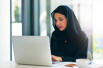 Image showing Woman, muslim and laptop for career is working at the office on the internet for dubai and technology. Professional, computer and arabic with a hijab is on the web to design at a company with tech.