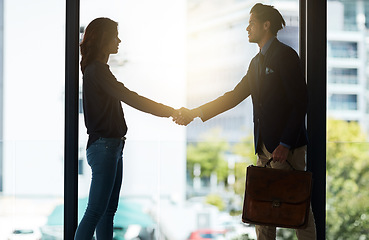 Image showing Silhouette, handshake and business people in office for agreement, planning and teamwork. Corporate workplace, collaboration and man and woman shaking hands for partnership, thank you and welcome