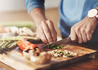 Image showing Cooking, chopping board and hands of man in kitchen for food, wellness and nutrition. Health, diet and dinner with closeup of male chef cutting vegetables with knife at home for lunch, vegan or salad