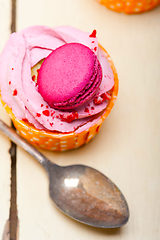 Image showing pink berry cream cupcake with macaroon on top