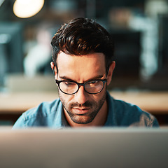 Image showing Focused man, face and glasses at computer in office for planning strategy, online research and reading email at night. Serious worker, desktop pc and website connection for business, internet or tech