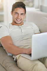 Image showing Laptop, sofa and portrait of man doing remote work in his home, house or apartment with smile and relax. Couch, happy and young male person or student typing a project online, website or web