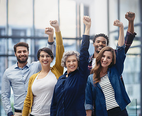 Image showing Celebration, diversity and business people with a fist in office for confidence, motivation and teamwork. Happy, smile and group of multiracial corporate employees to celebrate success in workplace.