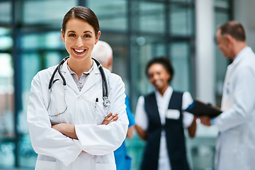 Image showing Healthcare, happiness and portrait of woman doctor with confident smile in hospital for leadership in medicine. Health care career, wellness and medical professional with mockup in lobby of clinic.