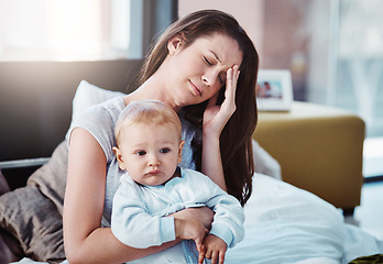 Image showing Stress, headache and a a mother with her baby in a bedroom of their home together in the morning. Children, family and burnout with a tired mama sitting on a bed with an infant son as a single parent