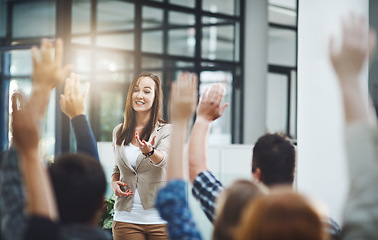 Image showing Woman at seminar, audience with hands up for questions and answers at training presentation or meeting. Feedback, opinion and ideas, group of people at conference with hand in air, coaching and faq.