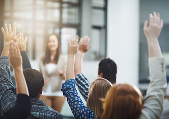 Image showing Seminar, audience from back with hands up for questions and answers at training presentation or meeting. Feedback, opinion and ideas, group of people at conference, hand in air and talk at tradeshow.