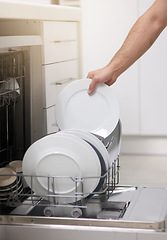 Image showing Cleaning, loading dishwasher and hands with plates in the kitchen for housework and responsibility. Lifestyle, morning and a person doing housekeeping, organizing crockery and clean equipment