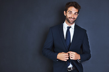 Image showing Portrait, smile and mockup with a business man in studio on a blue background for contemporary corporate style. Success, professional and a confident male employee in a suit for executive fashion