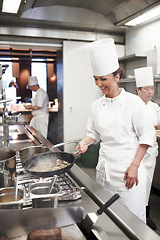 Image showing Chef, woman and frying in restaurant kitchen, catering service and prepare food for fine dining. Professional, cooking and female person saute meat with cook pan making meal nutrition for hospitality