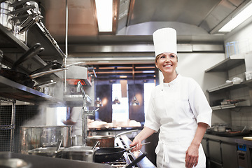 Image showing Chef, woman and smile with frying pan in kitchen, catering service and prepare food for fine dining in restaurant. Professional, cooking and female person saute, cook and thinking about hospitality.