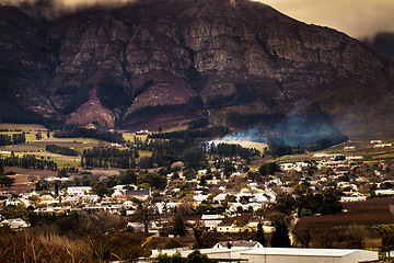 Image showing Urban development, suburb or cityscape by mountain, buildings and housing in Cape Town. Outdoor, landscape and mountains with houses, night and hill for real estate, property or holiday by skyline