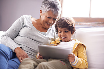 Image showing Tablet, grandmother and child education app at home on living room sofa with happiness and bonding. Family, house couch and lounge with senior woman and kid on technology watching a video with smile