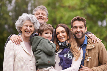 Image showing Happy and big family, child and portrait of people with kid in a park on outdoor vacation, holiday and faces together. Grandparents, happiness and parents bonding for love, care and in nature