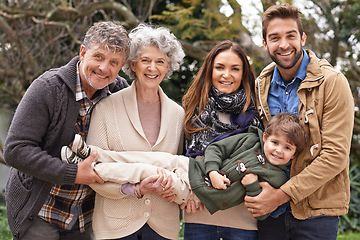 Image showing Happy family, grandparents and portrait of parents with kid in a park on outdoor vacation, holiday and excited together. Mother, faces and father playing with child for love, care and in nature