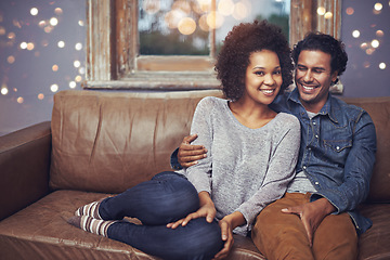 Image showing Portrait, love and happy couple relax on a sofa, romantic and bonding on date night with bokeh. Interracial relationship, face and man embrace woman on a couch, smile and chilling in a living room