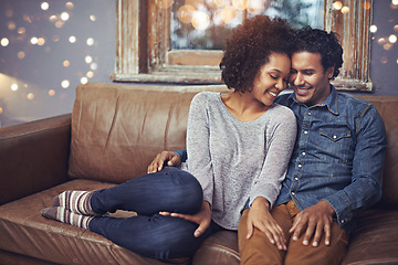 Image showing Hug, love and happy couple relax on a sofa, romantic and bonding on date night with bokeh. Interracial relationship, romance and man embrace woman on a couch, smile and chilling in a living room